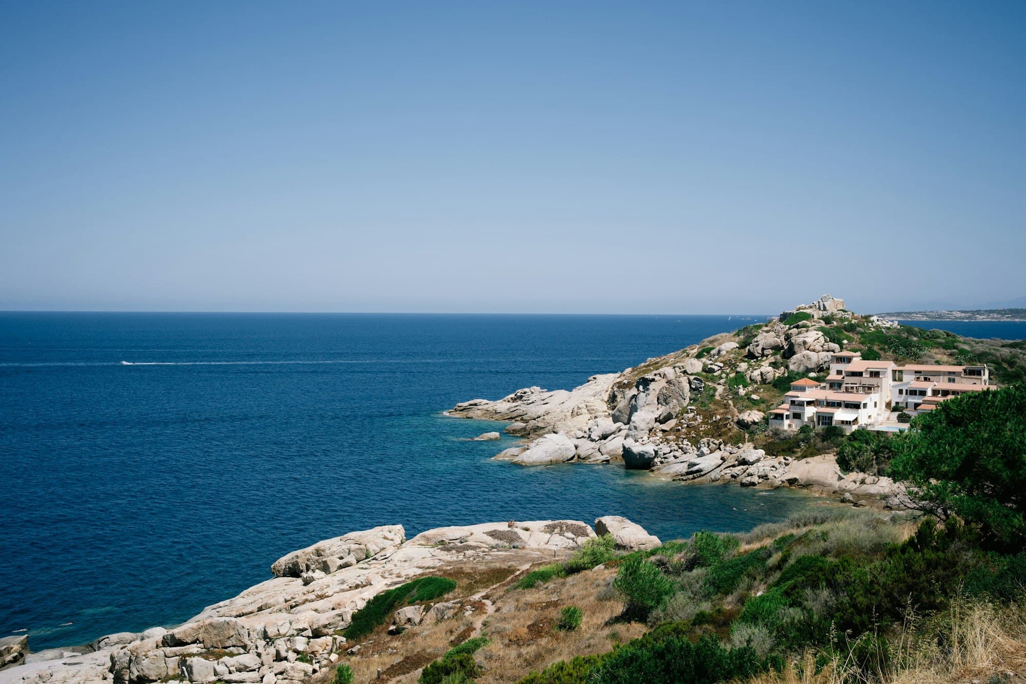 Granite coast and pale residences on Sardinia’s northeast shore.