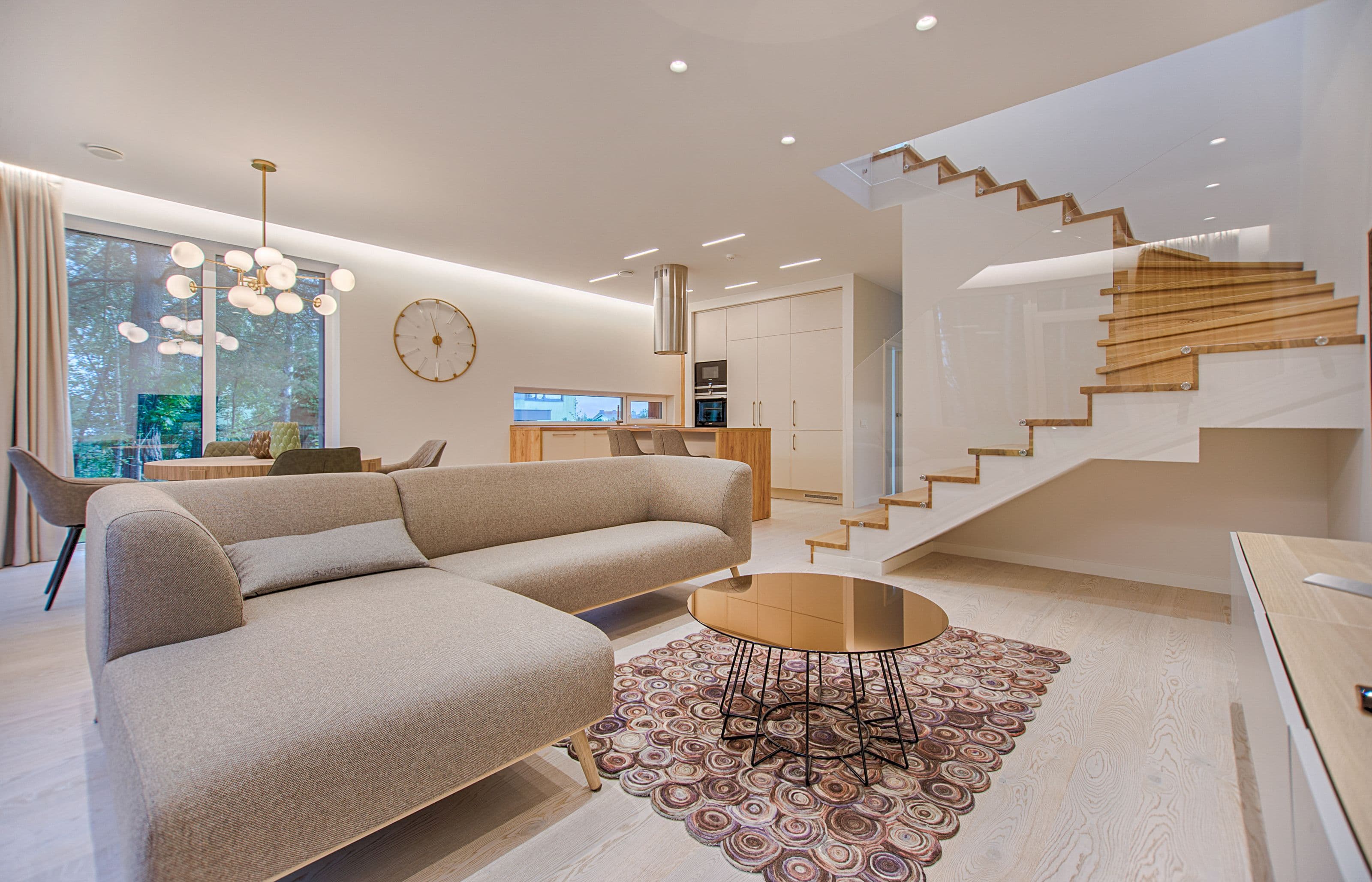 Fair-faced interior with a long sofa and a quiet, exact light.