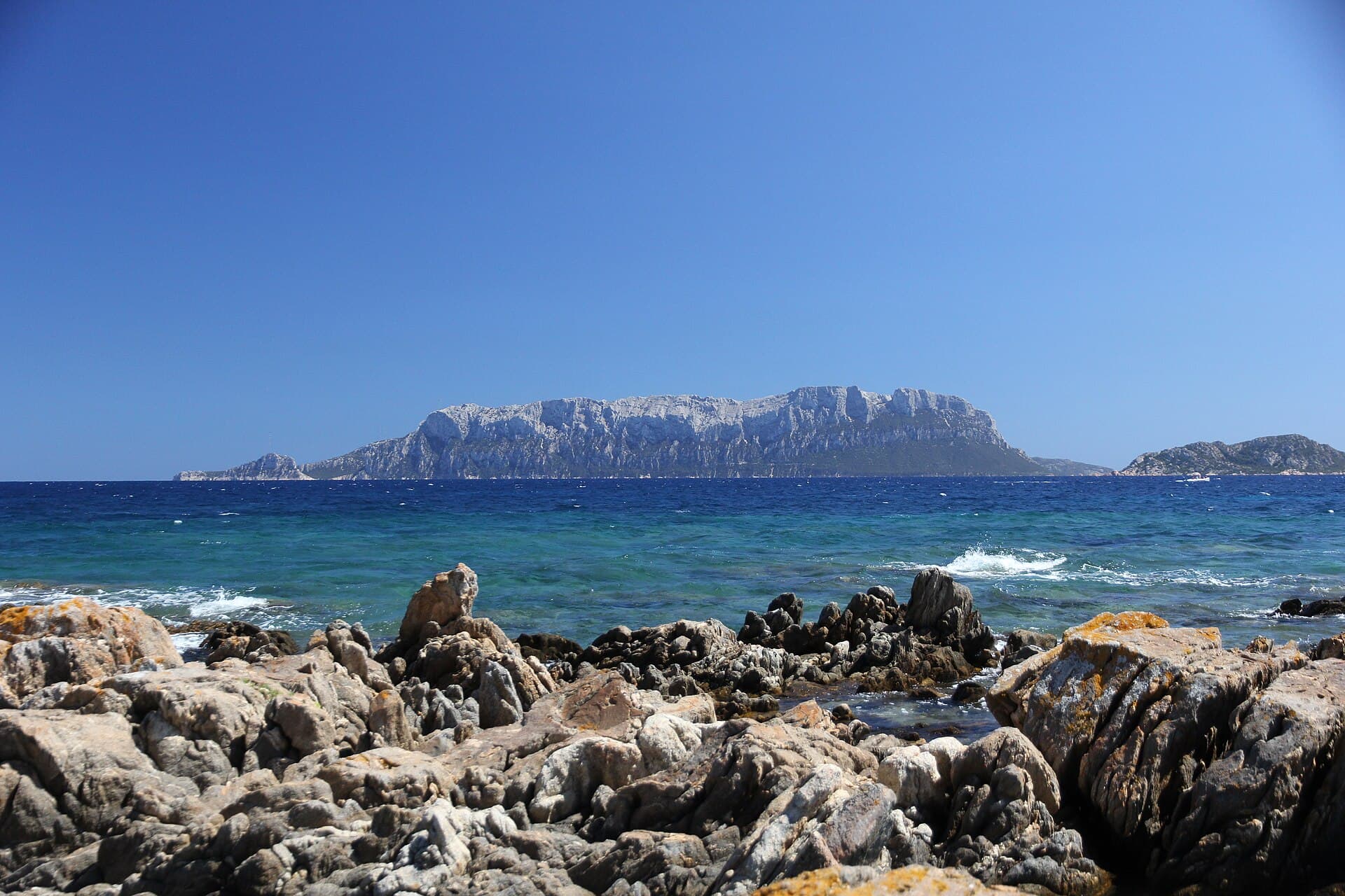 Tavolara rising from turquoise water.